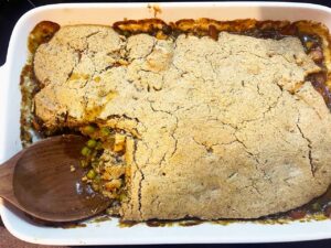 A portion of the casserole missing from the casserole dish..