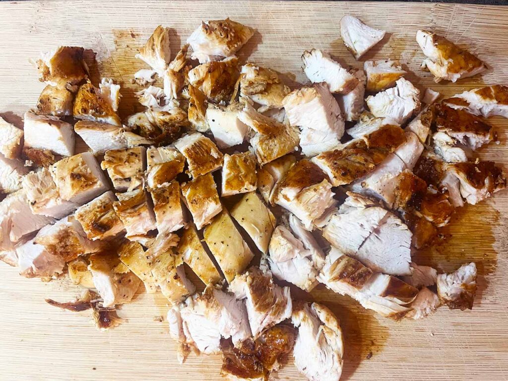 Two chicken breasts cut into small chunks.