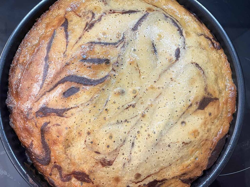 Baked Cream Cheese Brownies cooling in a baking pan.