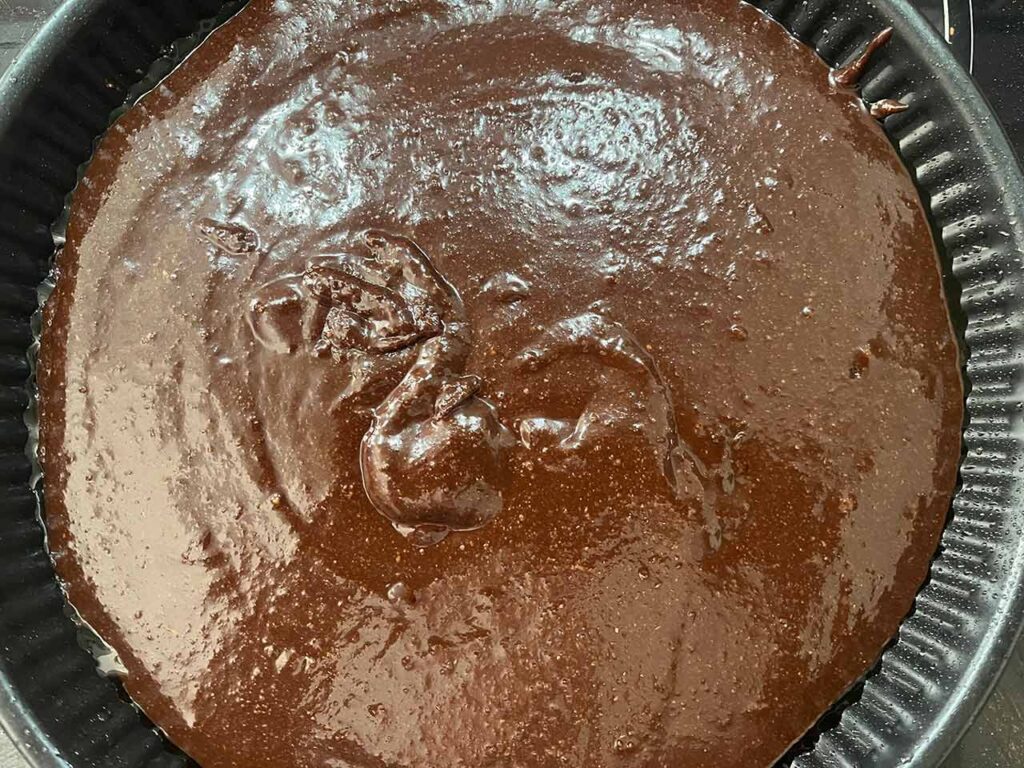 The brownie batter poured into the baking pan.
