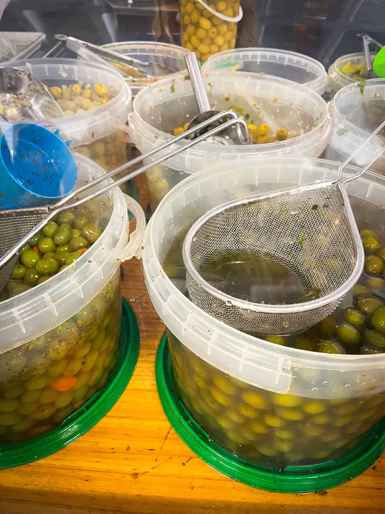 Olives in big buckets, for sale at the El Campello open market in Spain.