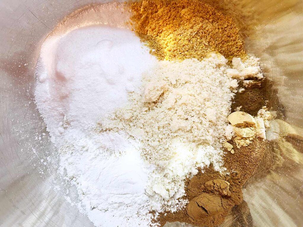 Dry pumpkin bar ingredients, unmixed, in a mixing bowl.