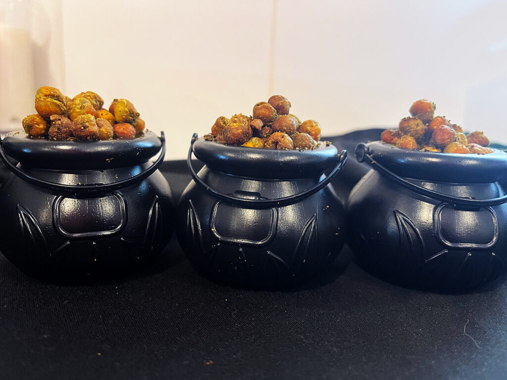 Three mini cauldrons filled with Poisoned Brew Bubbles sitting on a black surface.