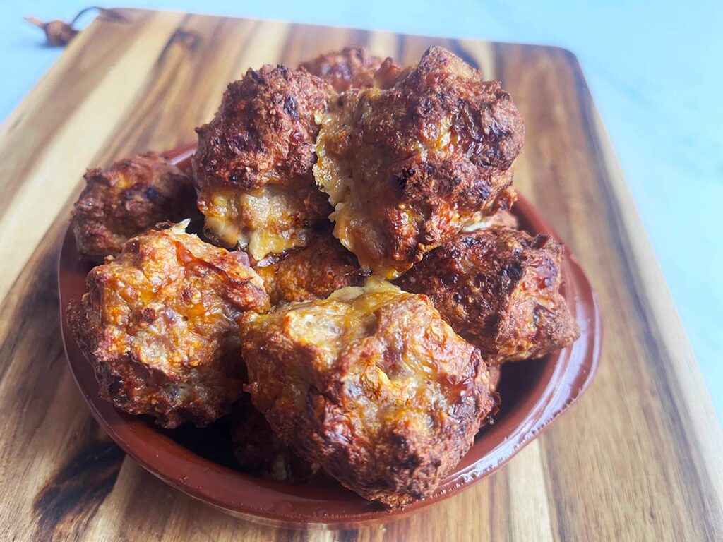 A front view of a brown plate holding a pile of Smokey Pumpkin Turkey Meatballs.