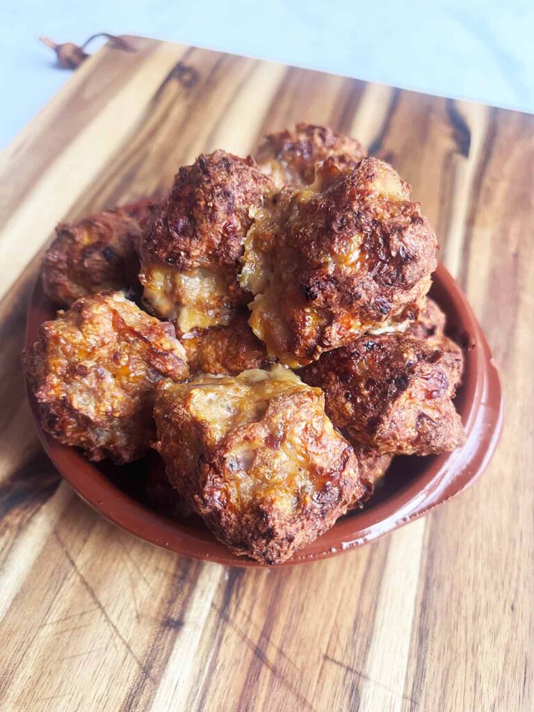 Angled front view of a brown plate piled high with Smokey Pumpkin Turkey Meatballs.