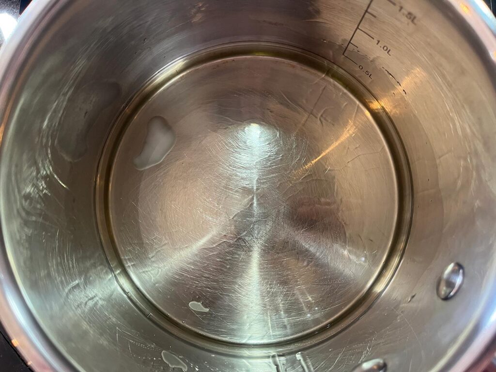 Coconut oil melting in a pot.