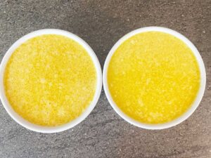 Vegan butter poured into two white ramekins.