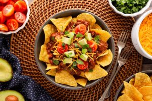 Overhead focus. A bowl filled with chili nachos.