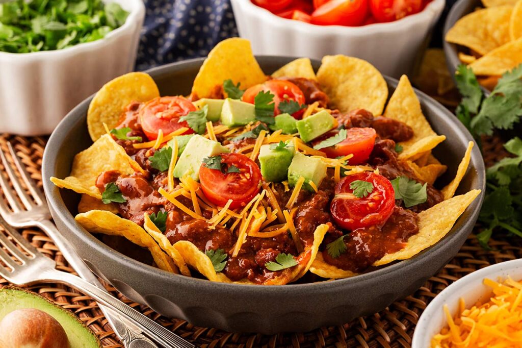 Front focus. A bowl filled with chili nachos.
