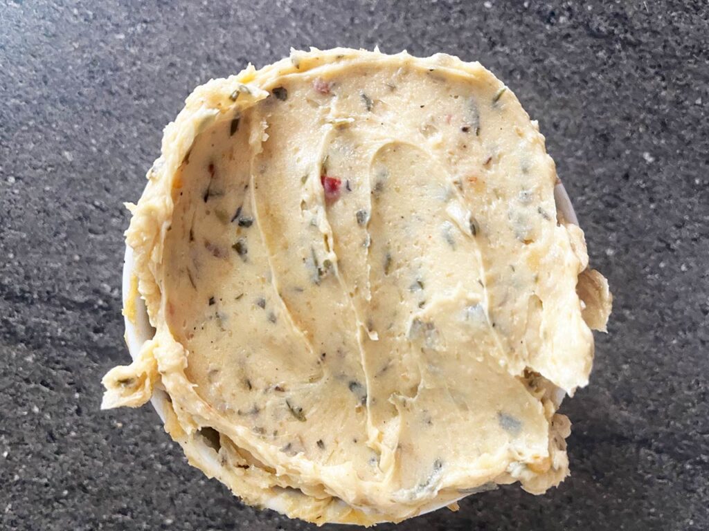 Overhead view of a bowl filled with Cowboy Butter.