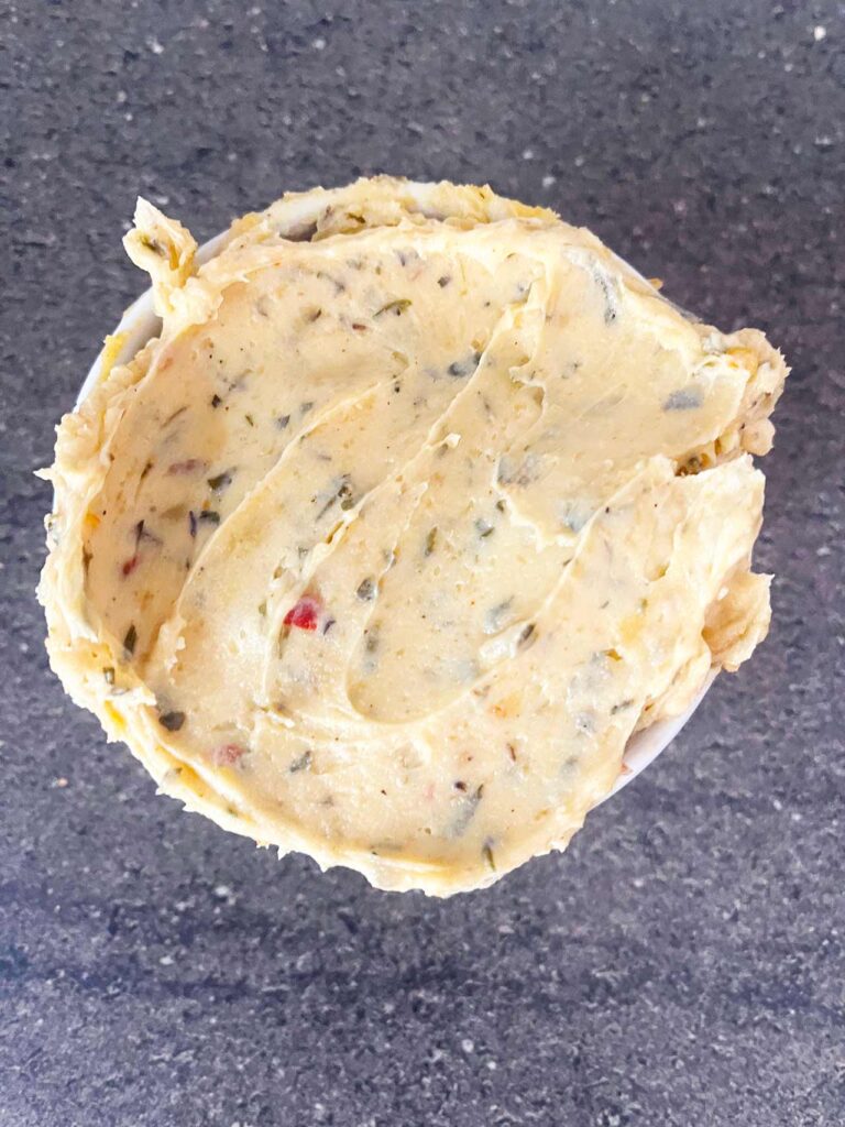 Overhead focus. A white ramekin filled with cowboy butter.