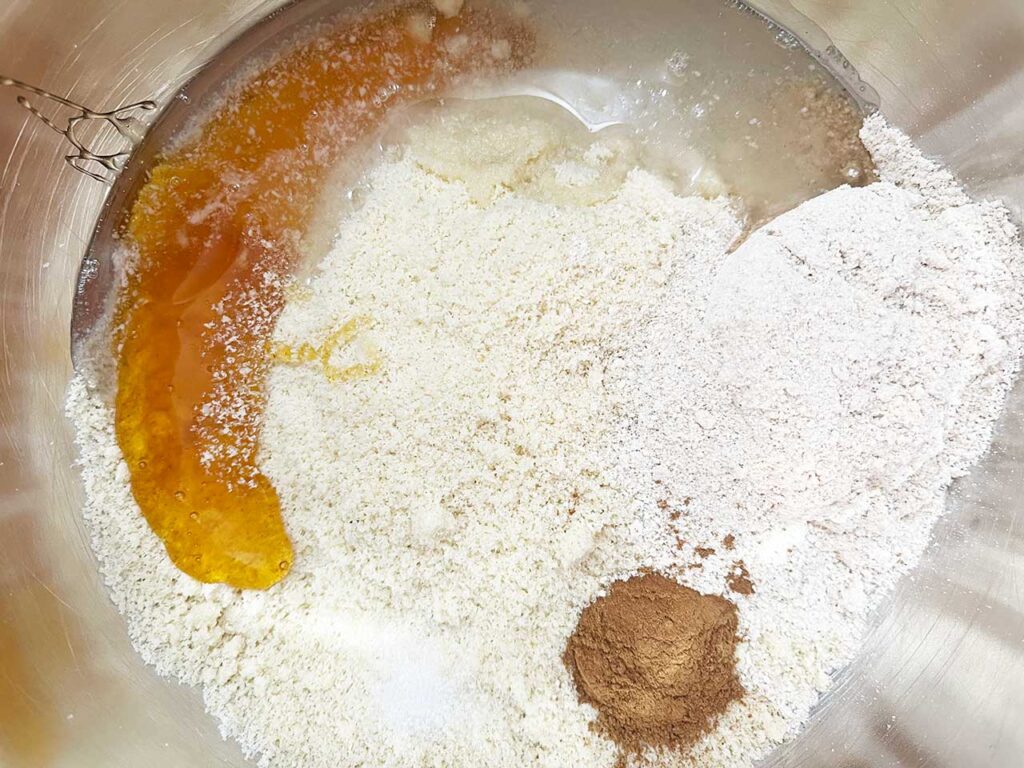 Wet ingredients added to Custard Pie crust ingredients in a mixing bowl.