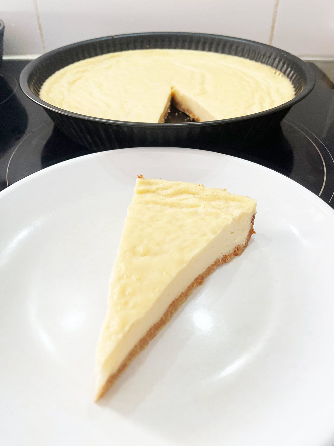 A slice of Custard Pie cut from the pan and placed on a white plate.