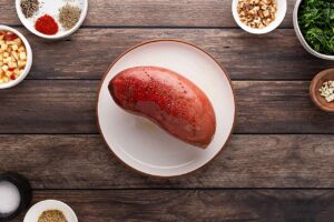 A baked sweet potato on a white plate.