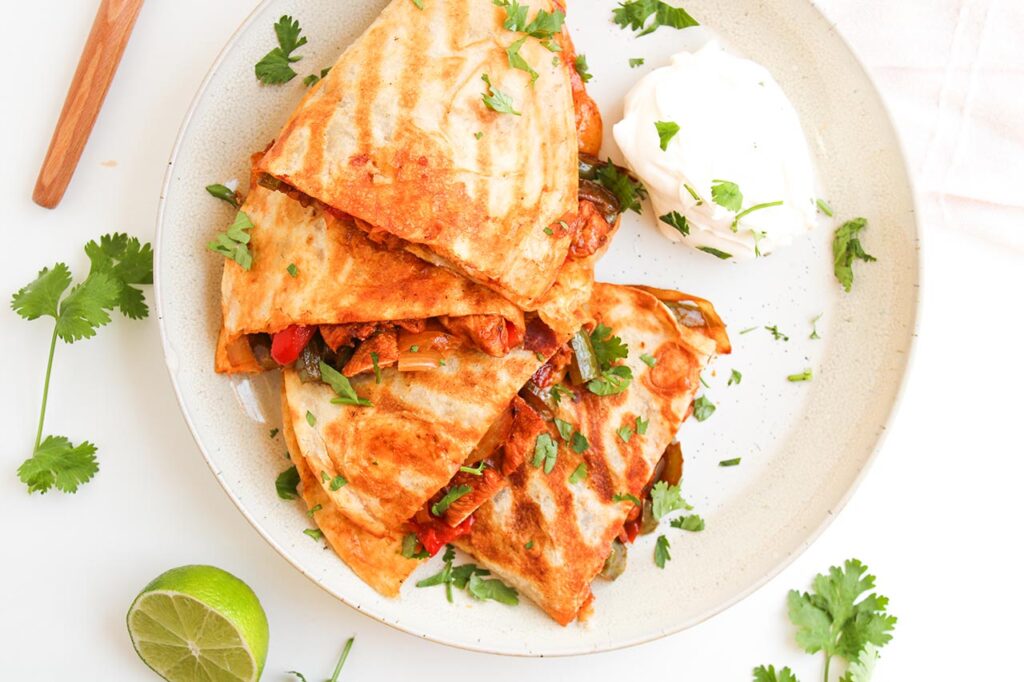 Overhead focus. Chicken Fajita Quesadillas on a white plate.