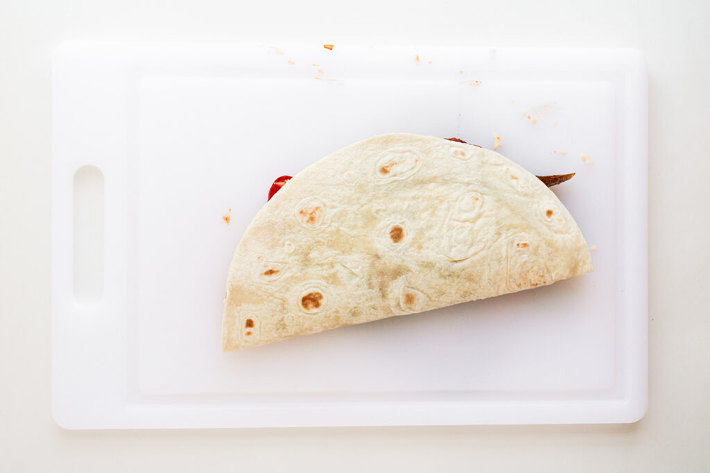 A tortilla folded over the filling into a taco.