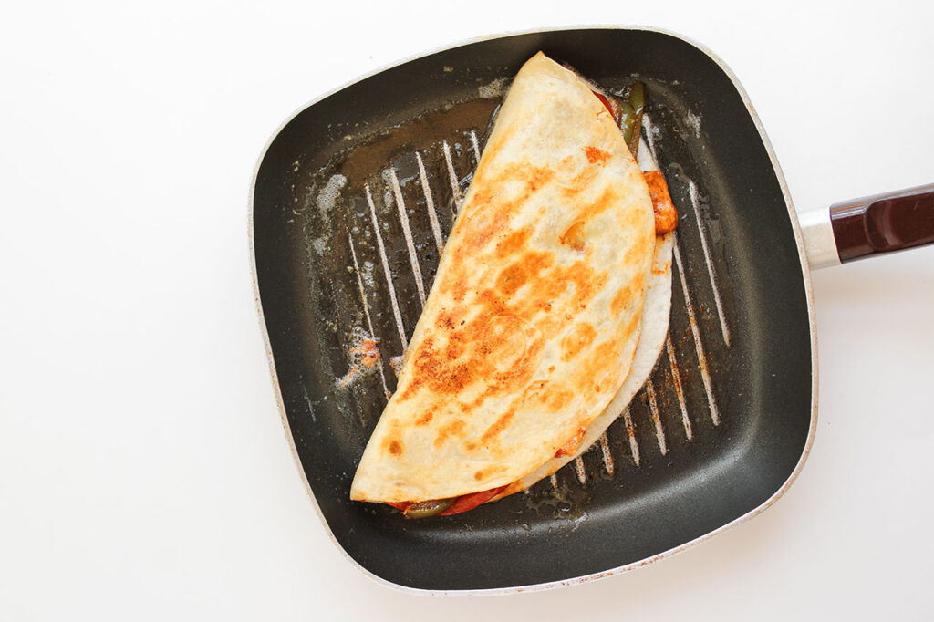 A Chicken Fajita Quesadilla in a skillet.
