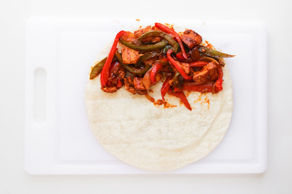 Fajita mix placed on a tortilla.