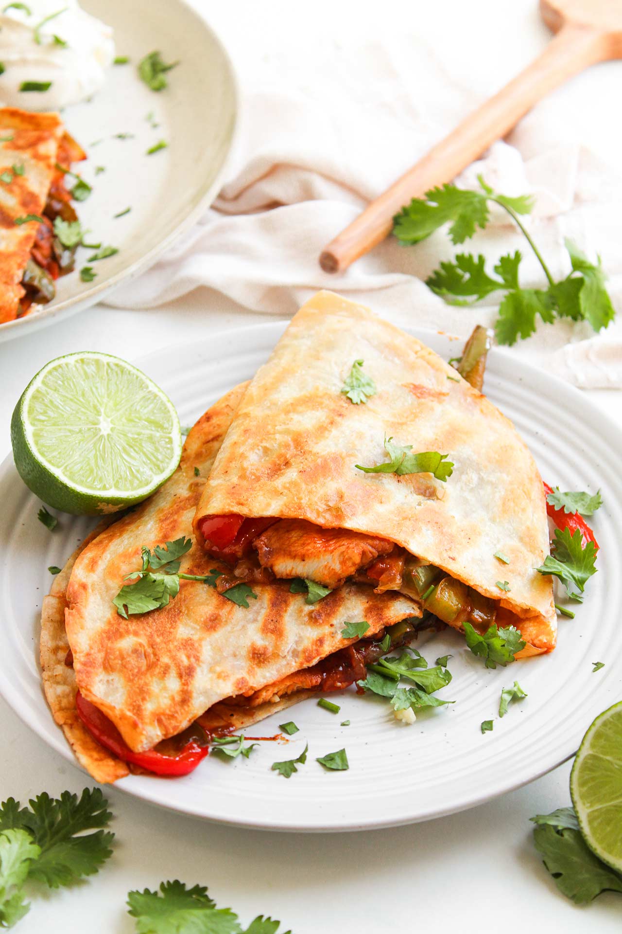 Two Chicken Fajita Quesadillas on a white plate.