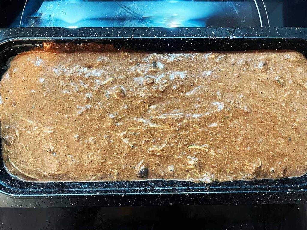Chocolate Zucchini Bread batter in a loaf pan.