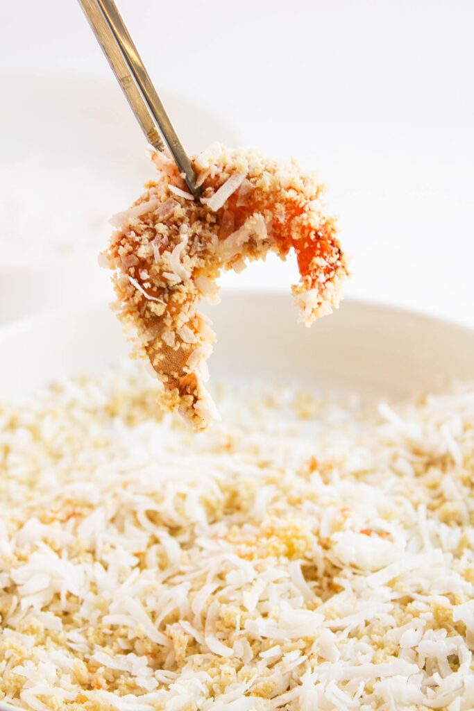 A shrimp dipped in bread crumbs and coconut.