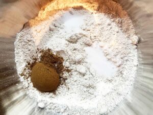 Dry ingredients for Oat Flour Ginger Molasses Cookies in a mixing bowl.