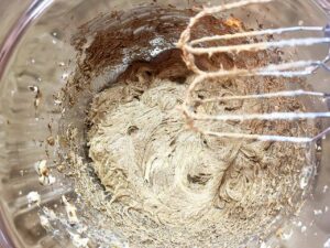 Wet ingredients for Oat Flour Ginger Molasses Cookies whisked together in a mixing bowl.