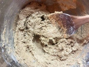 Dough for Oat Flour Ginger Molasses Cookies mixed together in a mixing bowl.