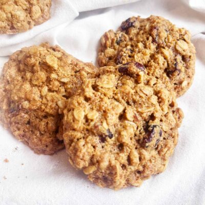 Closeup of Oat Flour Oatmeal Raisin Cookies on a white towel.