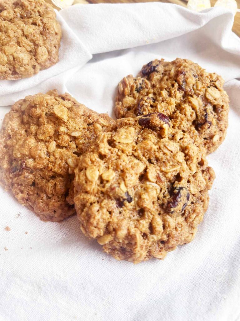 Closeup of Oat Flour Oatmeal Raisin Cookies on a white towel.