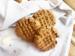 Overhead focus. Oat Flour Peanut Butter Cookies on a white towel.
