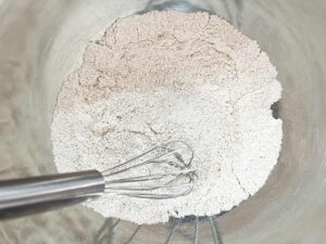 Dry ingredients for Oat Flour Peanut Butter Cookies whisked together in a mixing bowl.
