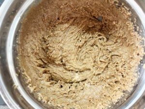 Peanut butter and sweetener mixed together in a mixing bowl.