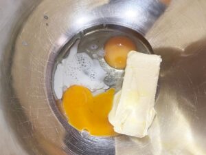 Wet ingredients for Oat Flour Sugar Cookies in a mixing bowl.