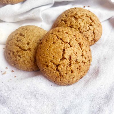 Front view of three Oat Flour Sugar Cookies on a white towel.