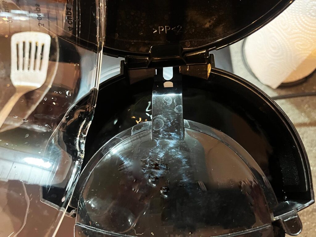 Pouring water into a coffee machine.