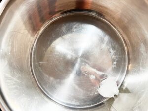 Melting coconut oil in a pot.