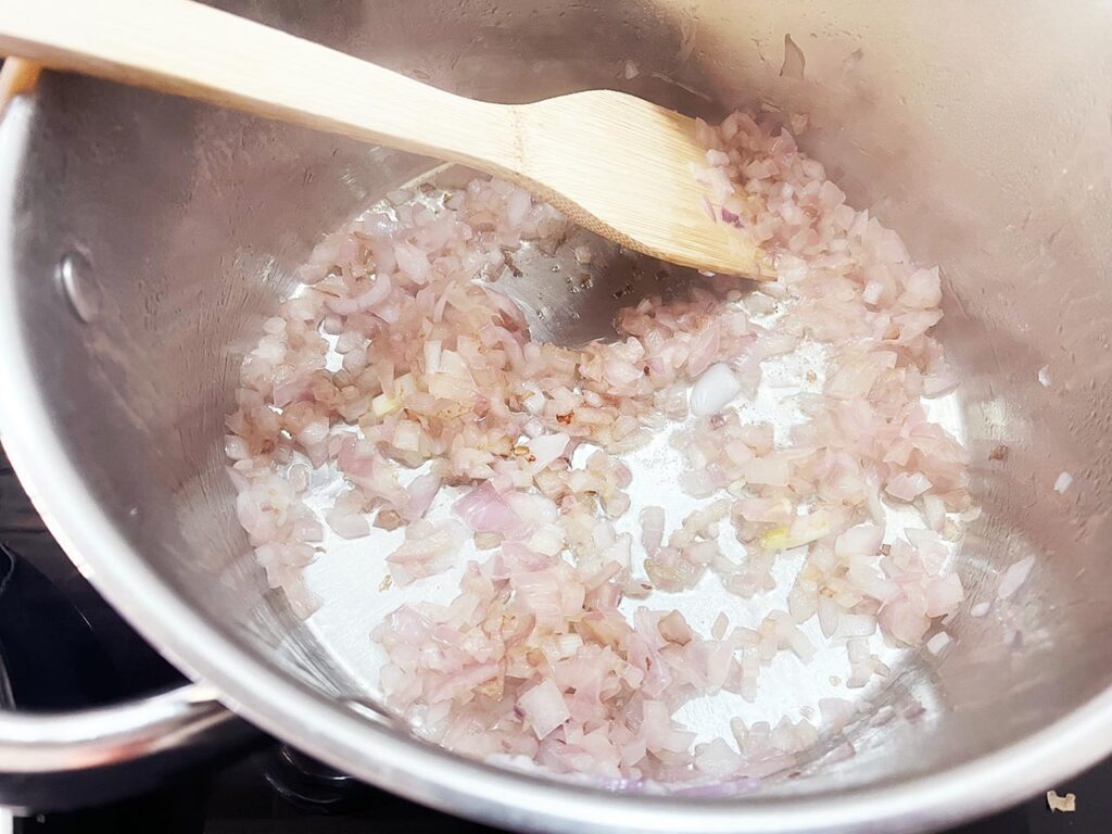 Sautéd onions and garlic in a pot.