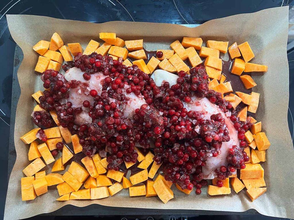 Cranberry mix spooned over the top of the chicken and sweet potatoes.