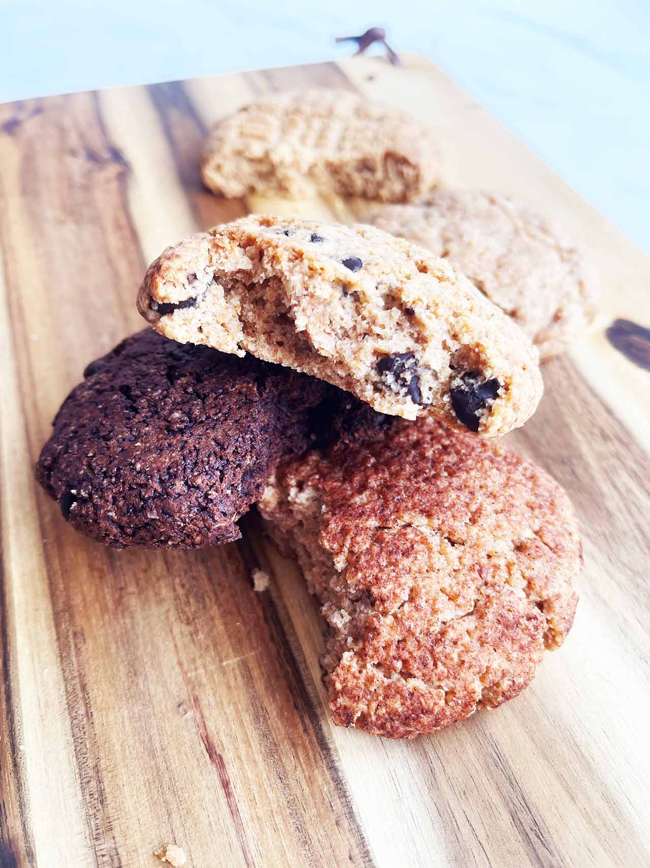 Partially eaten cookies on a wood cutting board.