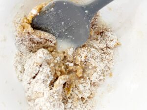 Milk and oil added to peanut butter cookie batter.