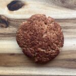 Overhead focus. A single snickerdoodle cookie on a wood surface.