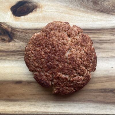 Overhead focus. A single snickerdoodle cookie on a wood surface.
