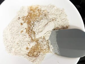 Wet ingredients added to dry snickerdoodle ingredients in a mixing bowl.