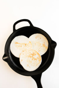 Warming tortillas in a skillet.
