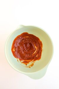 Overhead focus. Sauce for Street Corn Chicken Tacos in a bowl.