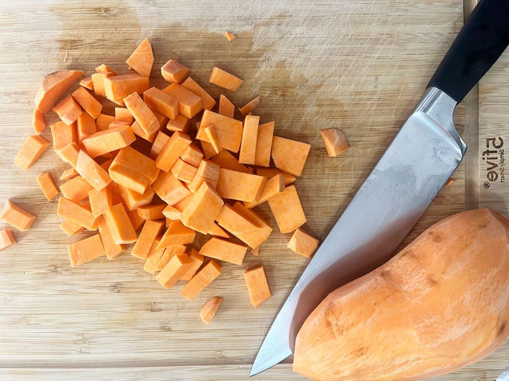 Overhead focus. Sweet potatoes cut on a cutting board.