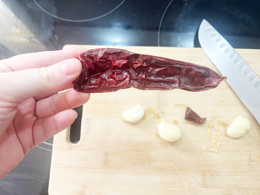 A larger red chili shown to compare how much you'll want for the recipe.