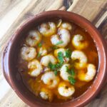 Overhead focus. A Cazuela dish filled with Gambas Al Ajillo.