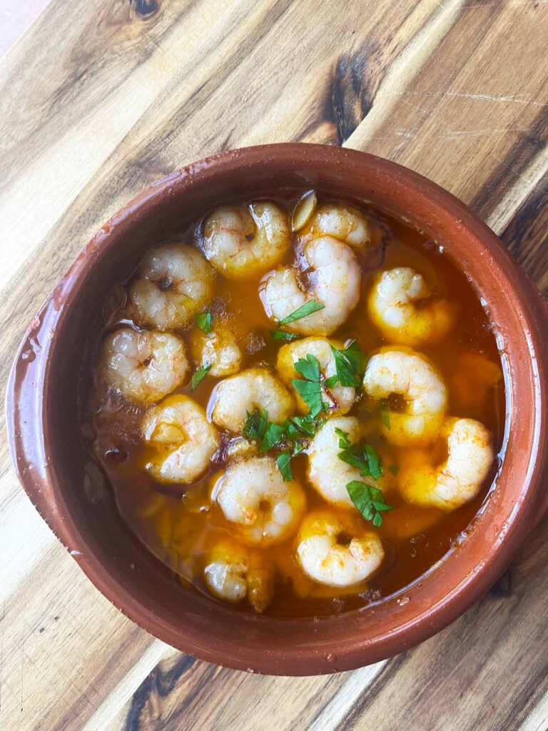 Overhead focus. A Cazuela dish filled with Gambas Al Ajillo.